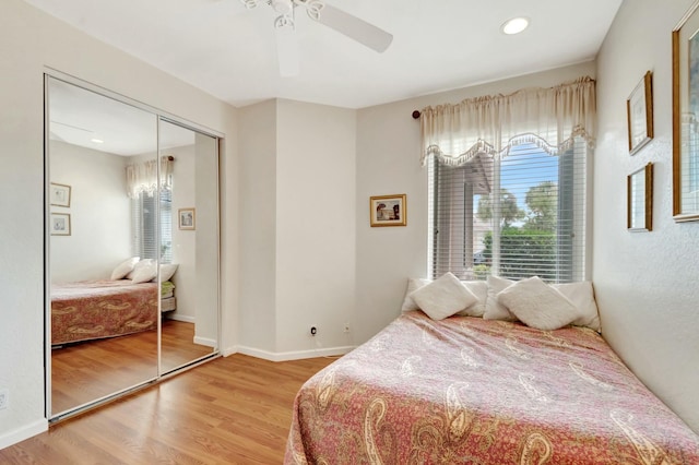 bedroom with recessed lighting, a ceiling fan, baseboards, a closet, and light wood-type flooring