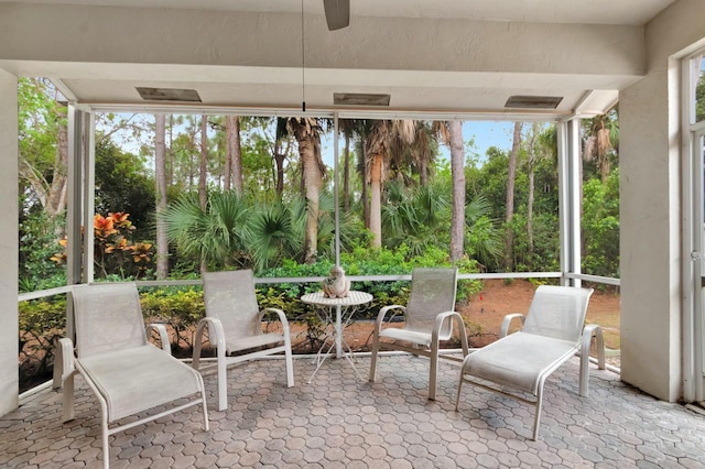 sunroom featuring plenty of natural light and ceiling fan