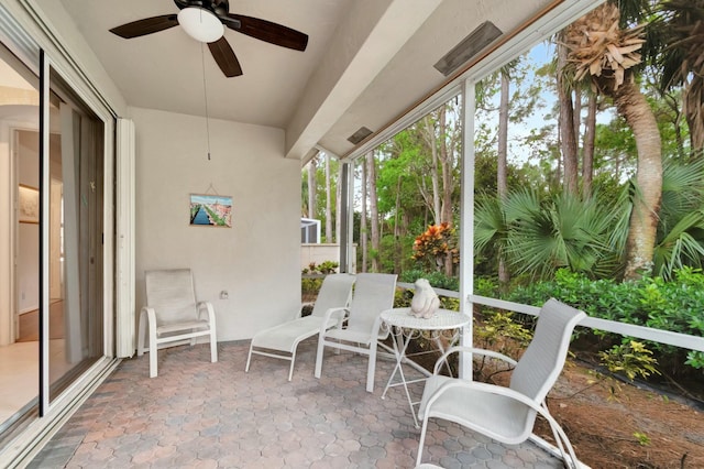 sunroom / solarium with a ceiling fan