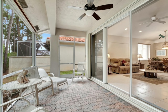 sunroom / solarium featuring ceiling fan