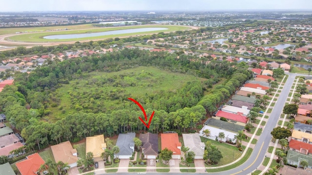 birds eye view of property featuring a residential view and a water view