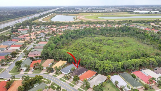 birds eye view of property with a water view and a residential view