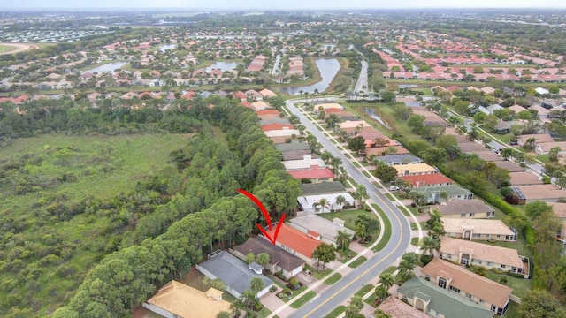 drone / aerial view with a residential view and a water view