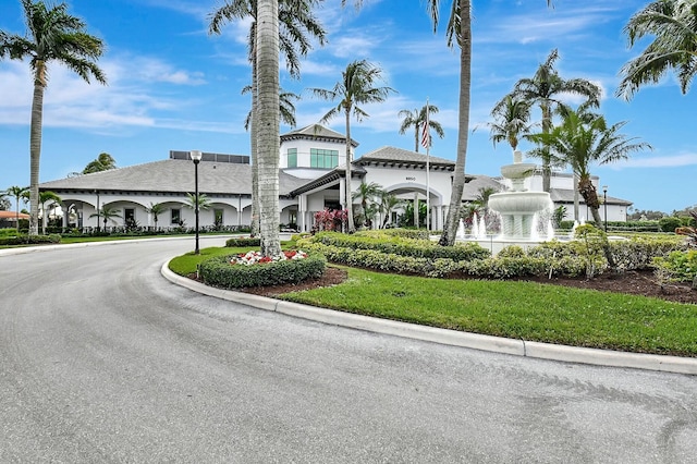 view of building exterior featuring curved driveway