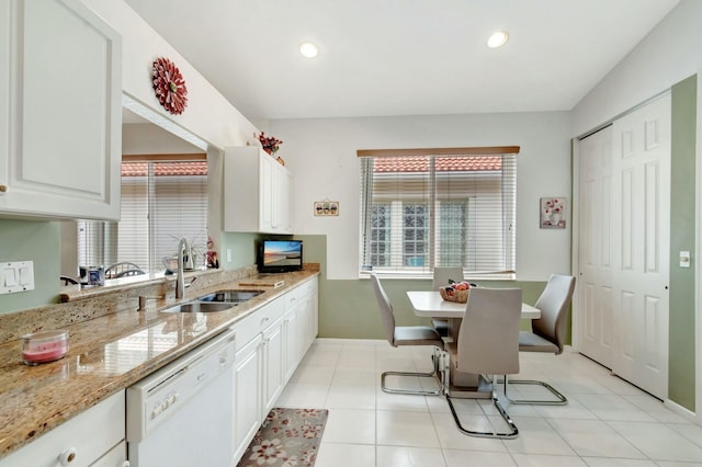 kitchen with dishwasher, a sink, white cabinetry, and light stone countertops