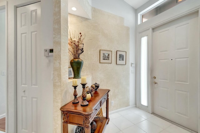 entryway featuring baseboards and light tile patterned flooring