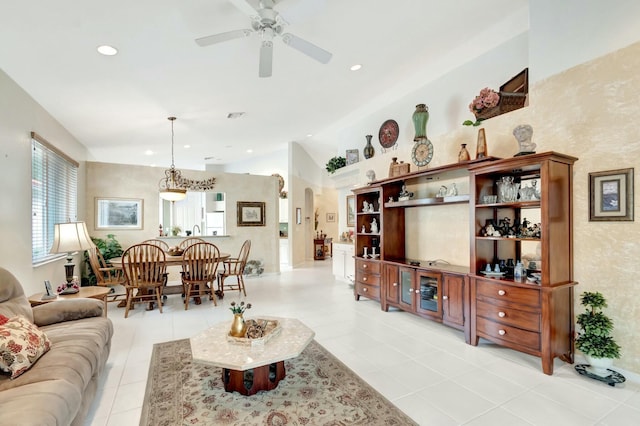 living room featuring arched walkways, ceiling fan, light tile patterned floors, lofted ceiling, and recessed lighting