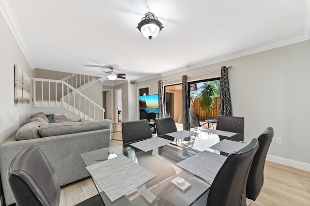 dining area with stairway, baseboards, crown molding, and light wood-style floors