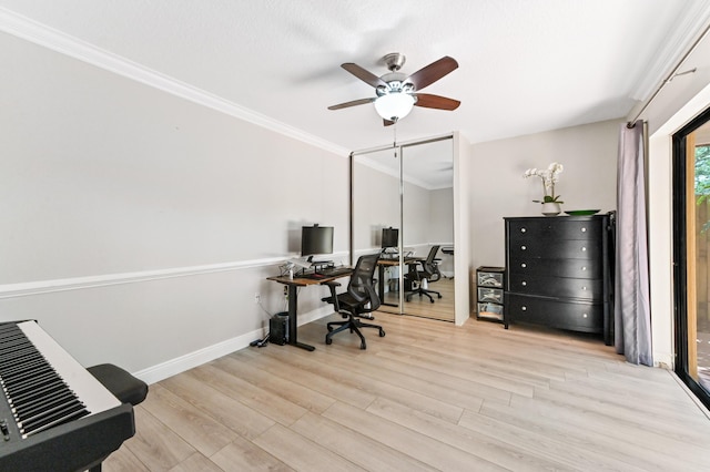 office space featuring crown molding, a ceiling fan, light wood-type flooring, and baseboards