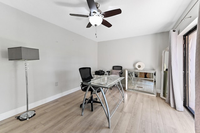 office space with baseboards, light wood finished floors, and ceiling fan