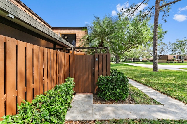 view of yard with fence and a gate