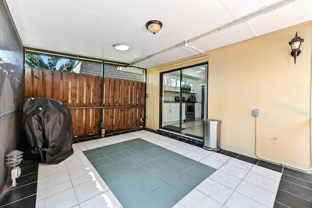 view of patio featuring area for grilling and fence