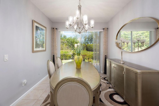 dining area featuring baseboards, a notable chandelier, and light tile patterned flooring