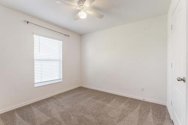 unfurnished room featuring baseboards, light carpet, and ceiling fan