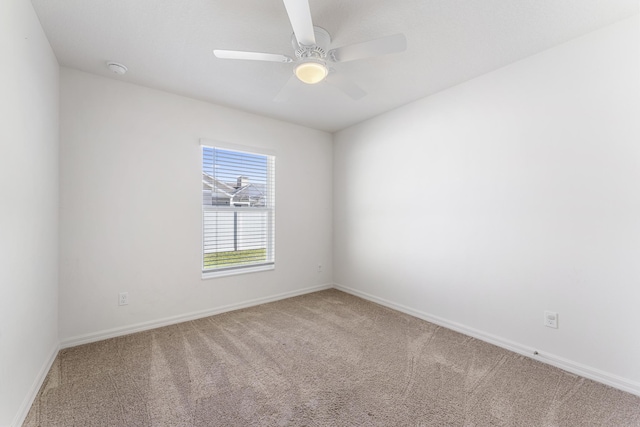 spare room featuring carpet flooring, baseboards, and a ceiling fan