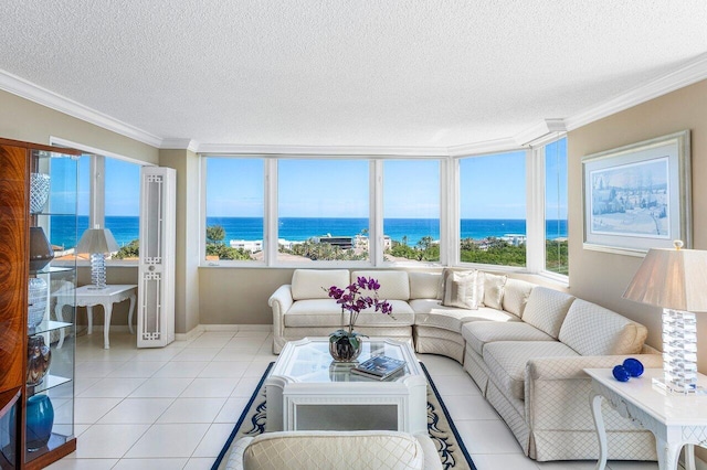 living area with light tile patterned flooring, a water view, a wealth of natural light, and ornamental molding