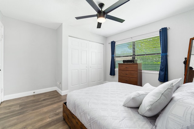 bedroom featuring a closet, ceiling fan, baseboards, and wood finished floors