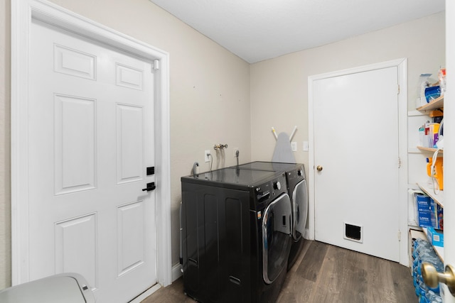 laundry room with laundry area, dark wood-style flooring, and washer and dryer