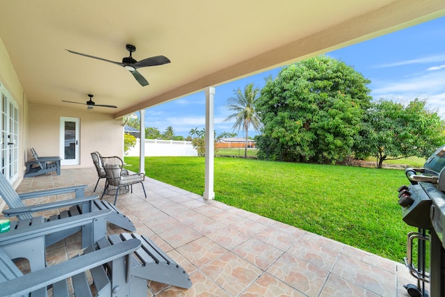 view of patio / terrace featuring fence and a ceiling fan