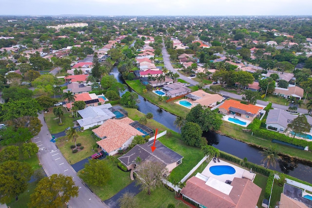 bird's eye view featuring a residential view and a water view