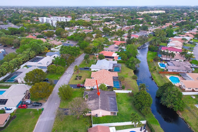 drone / aerial view featuring a water view and a residential view