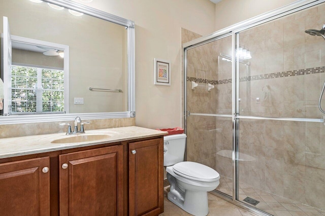 bathroom with toilet, a shower stall, and vanity