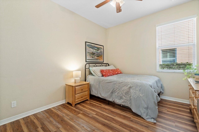 bedroom featuring ceiling fan, baseboards, and wood finished floors