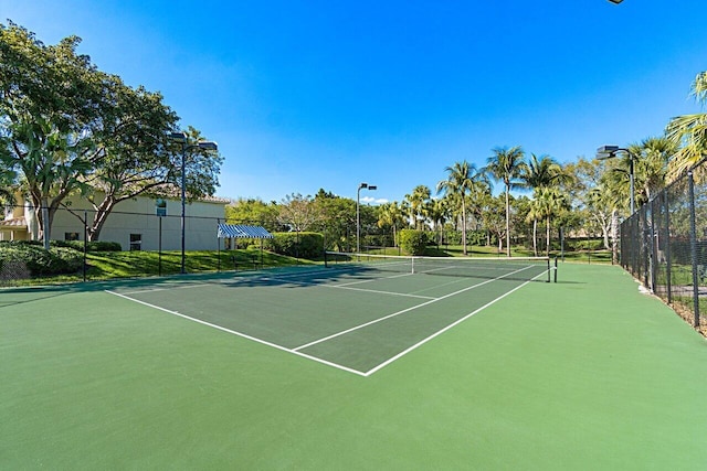 view of tennis court featuring fence