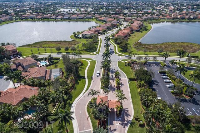 drone / aerial view featuring a water view and a residential view