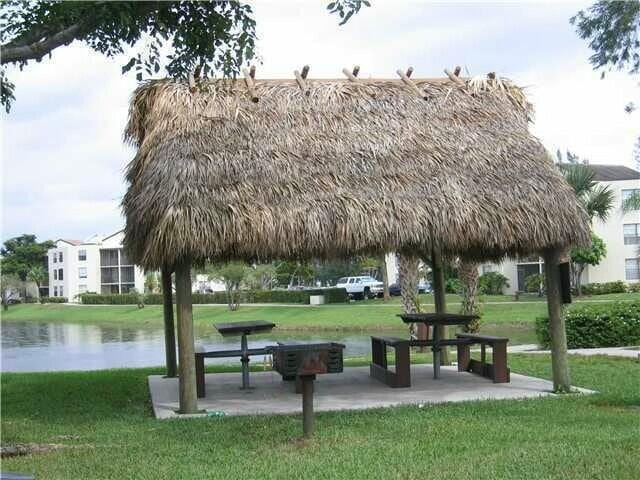 view of community featuring a water view, a gazebo, and a yard