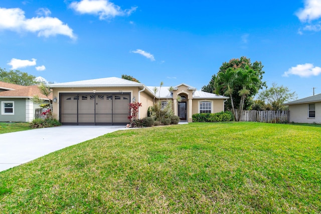 ranch-style house with stucco siding, fence, concrete driveway, a front yard, and a garage