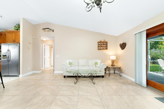 living area with baseboards, lofted ceiling, and light tile patterned flooring