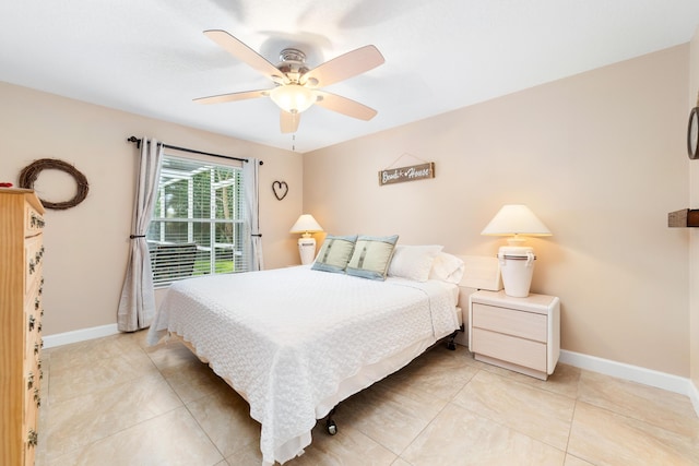 bedroom featuring light tile patterned floors, baseboards, and ceiling fan