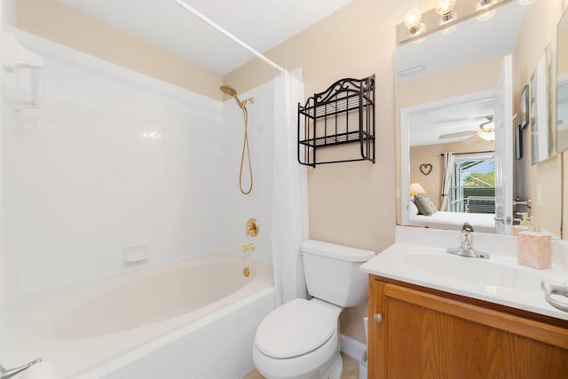 ensuite bathroom with toilet, shower / tub combo with curtain, ensuite bathroom, vanity, and a ceiling fan