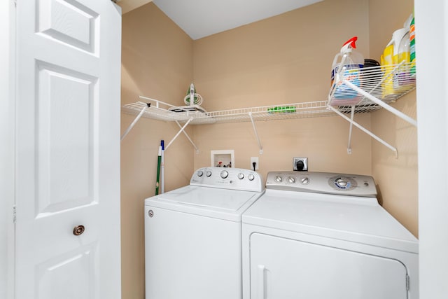 clothes washing area with washer and dryer and laundry area