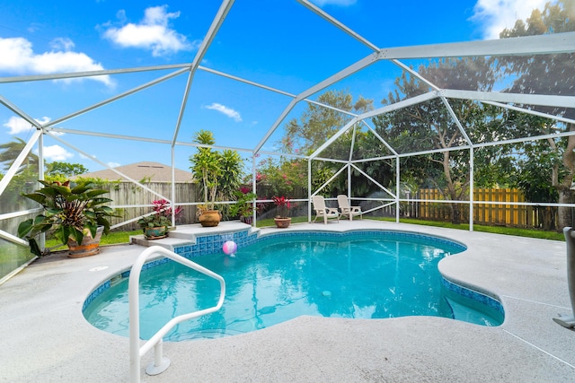 view of pool featuring a fenced in pool, a patio, a fenced backyard, and glass enclosure