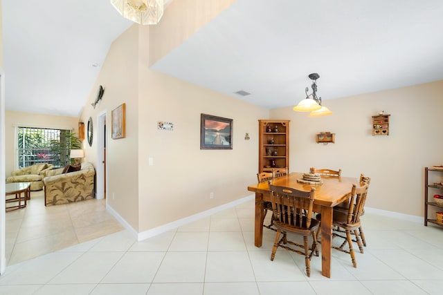 dining space featuring light tile patterned floors and baseboards