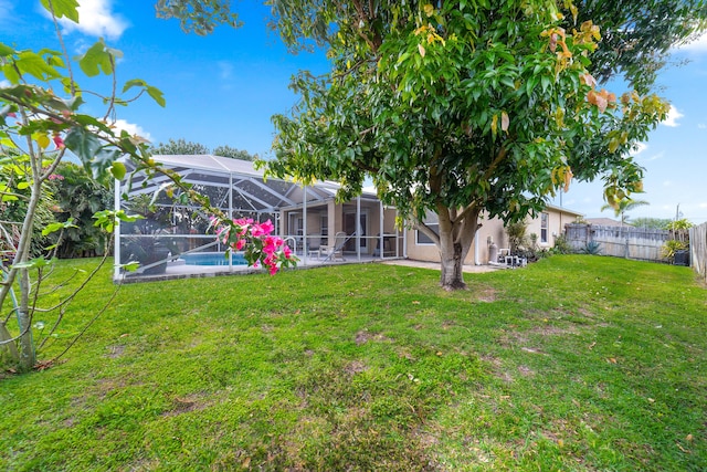 view of yard with a fenced in pool, a patio, a lanai, and fence