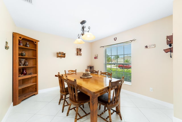 dining room featuring baseboards and light tile patterned flooring