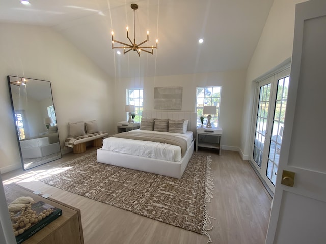 bedroom featuring french doors, high vaulted ceiling, and wood finished floors