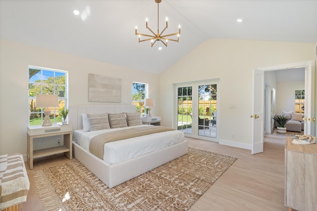bedroom with access to outside, a chandelier, light wood-type flooring, multiple windows, and high vaulted ceiling