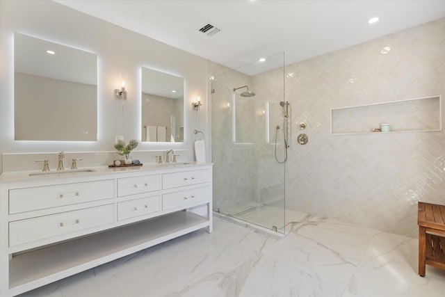 bathroom featuring walk in shower, double vanity, marble finish flooring, and recessed lighting