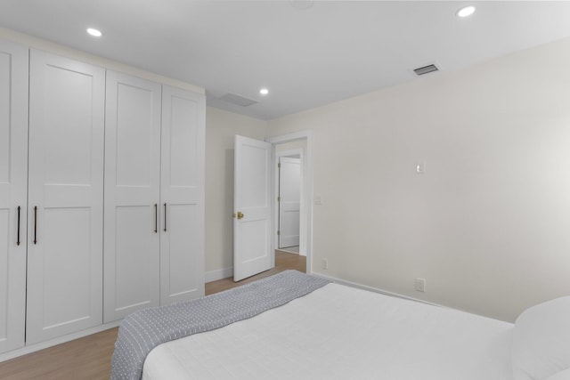 108 NW 4th Ave, Delray Beach, FL 33444 - bedroom featuring light wood-style floors, recessed lighting, baseboards, and a closet