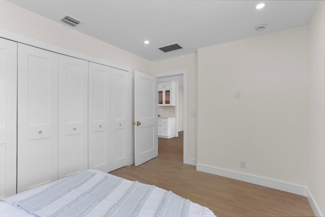 108 NW 4th Ave, Delray Beach, FL 33444 - bedroom featuring light wood-type flooring, baseboards, recessed lighting, and a closet