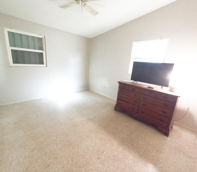 living area featuring ceiling fan and vaulted ceiling