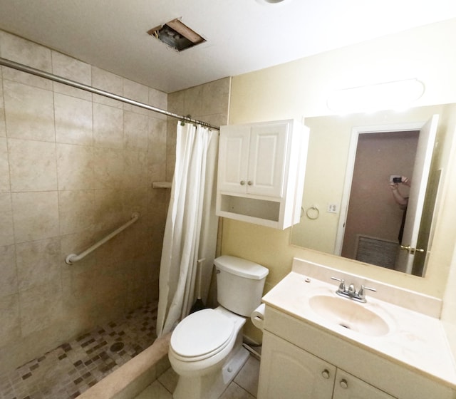 bathroom with a stall shower, tile patterned flooring, vanity, and toilet