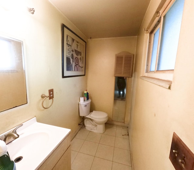 bathroom featuring toilet, tile patterned floors, a wealth of natural light, and vanity