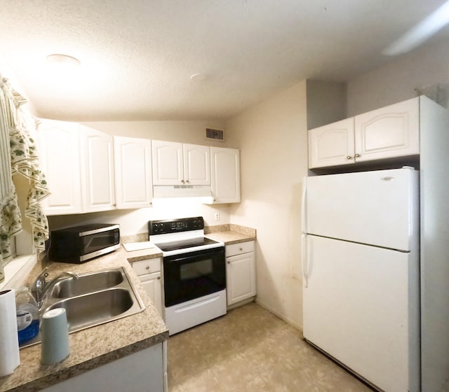 kitchen featuring white appliances, under cabinet range hood, white cabinetry, and a sink