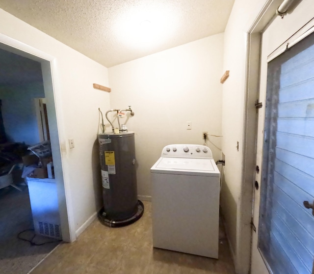 clothes washing area with water heater, a textured ceiling, washer / dryer, laundry area, and baseboards