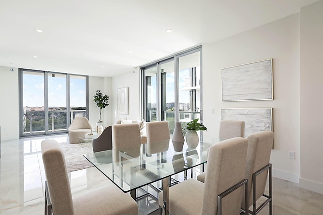 dining space with recessed lighting, a wall of windows, and baseboards